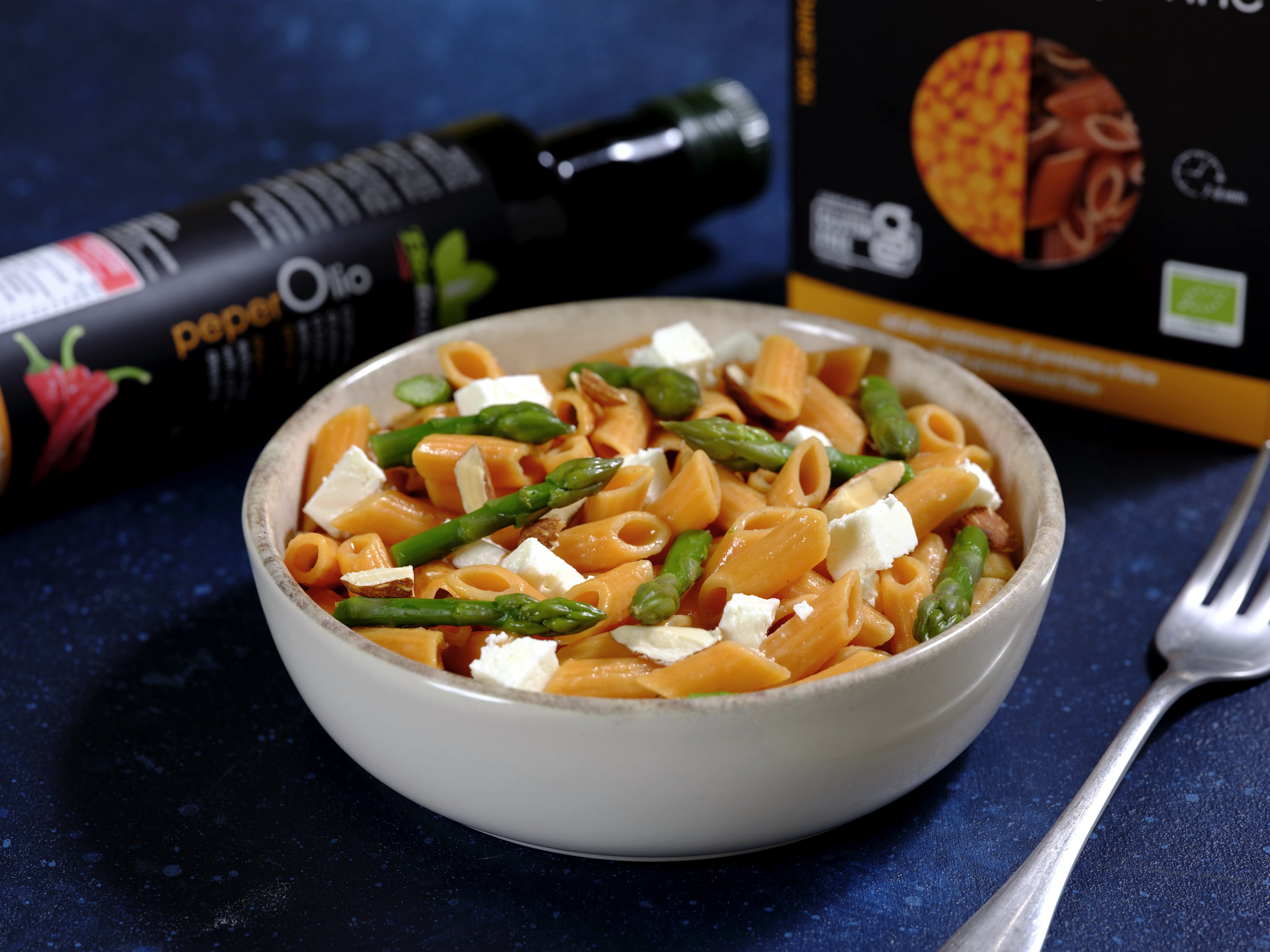 Lentil mezze penne with feta cheese, asparagus, almonds and Peperolio